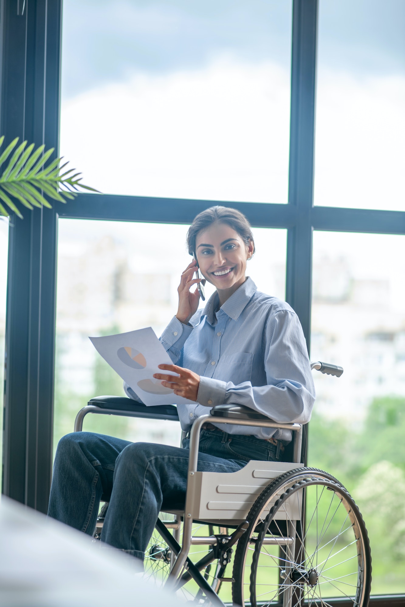 A disabled young woman talking on the phone